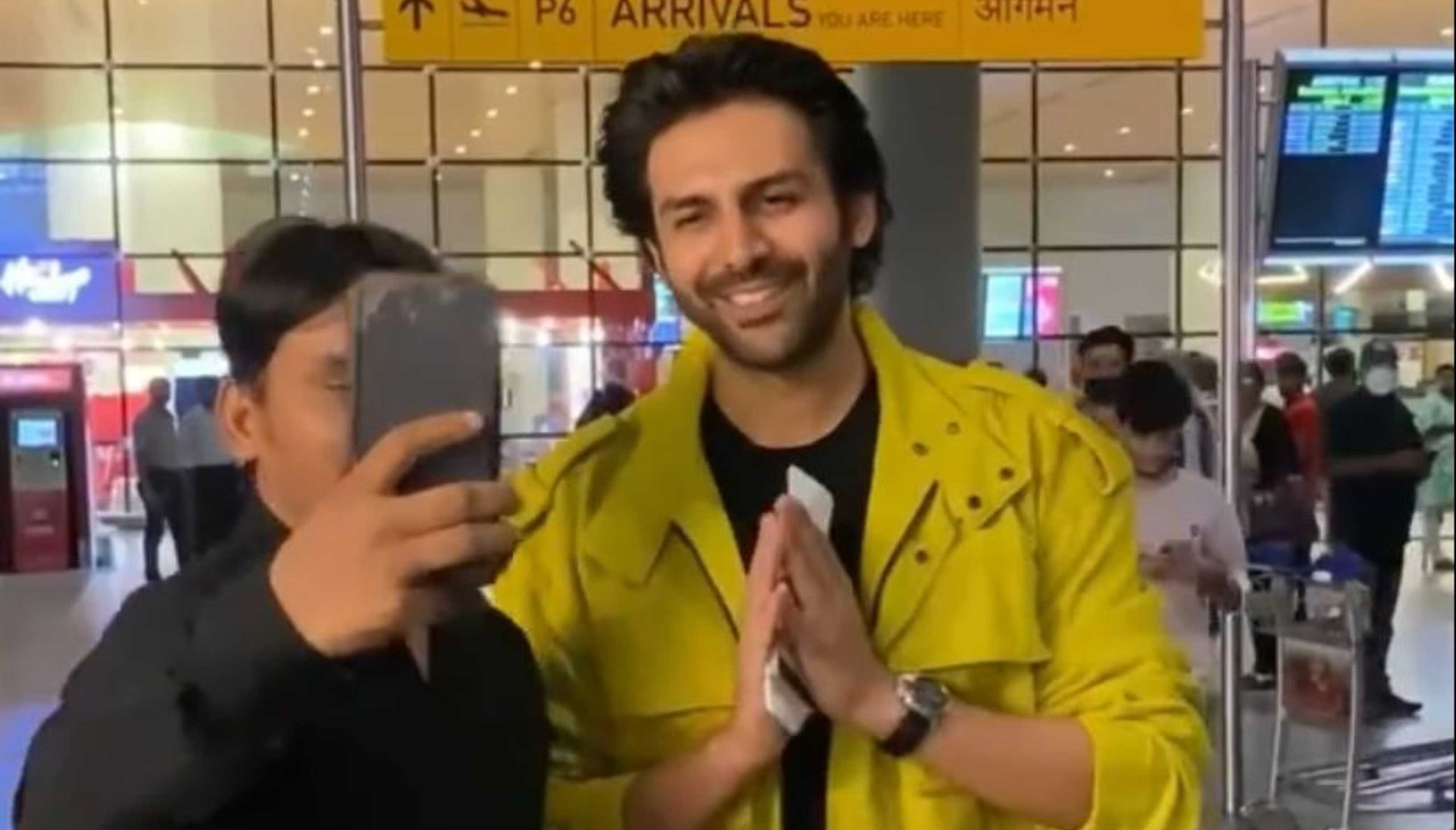 Kartik Aaryan returns from Europe in a yellow jacket, obliges fans with back to back selfies; watch