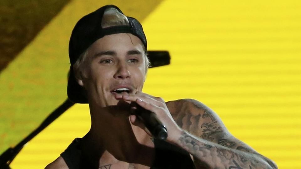 Justin Bieber cuddles up to mystery woman after his Rio de Janeiro concert. Pics...